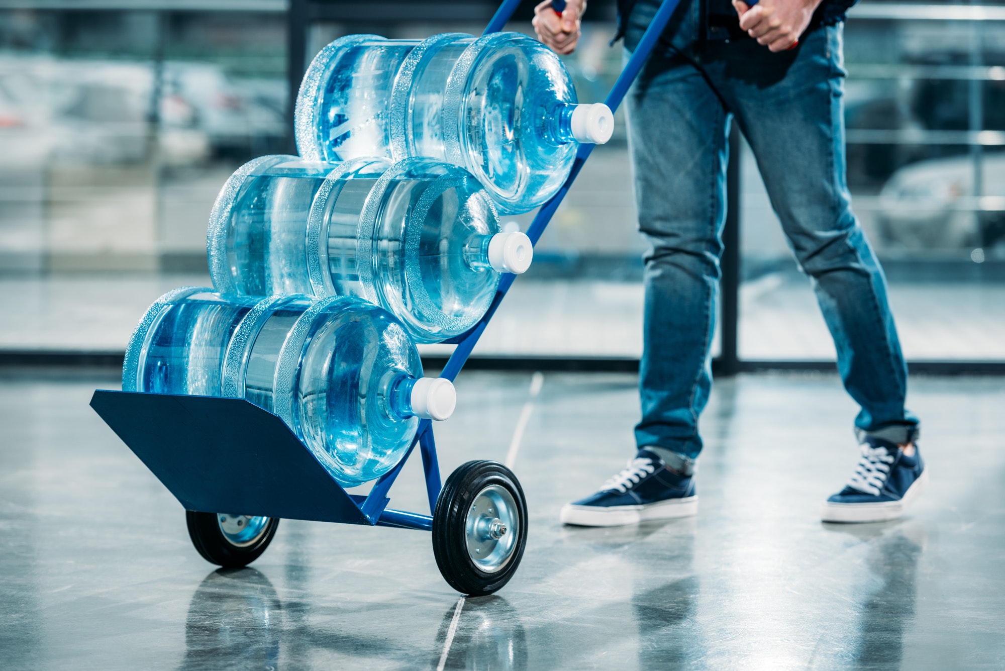 loader-pushing-cart-with-water-bottles.jpg